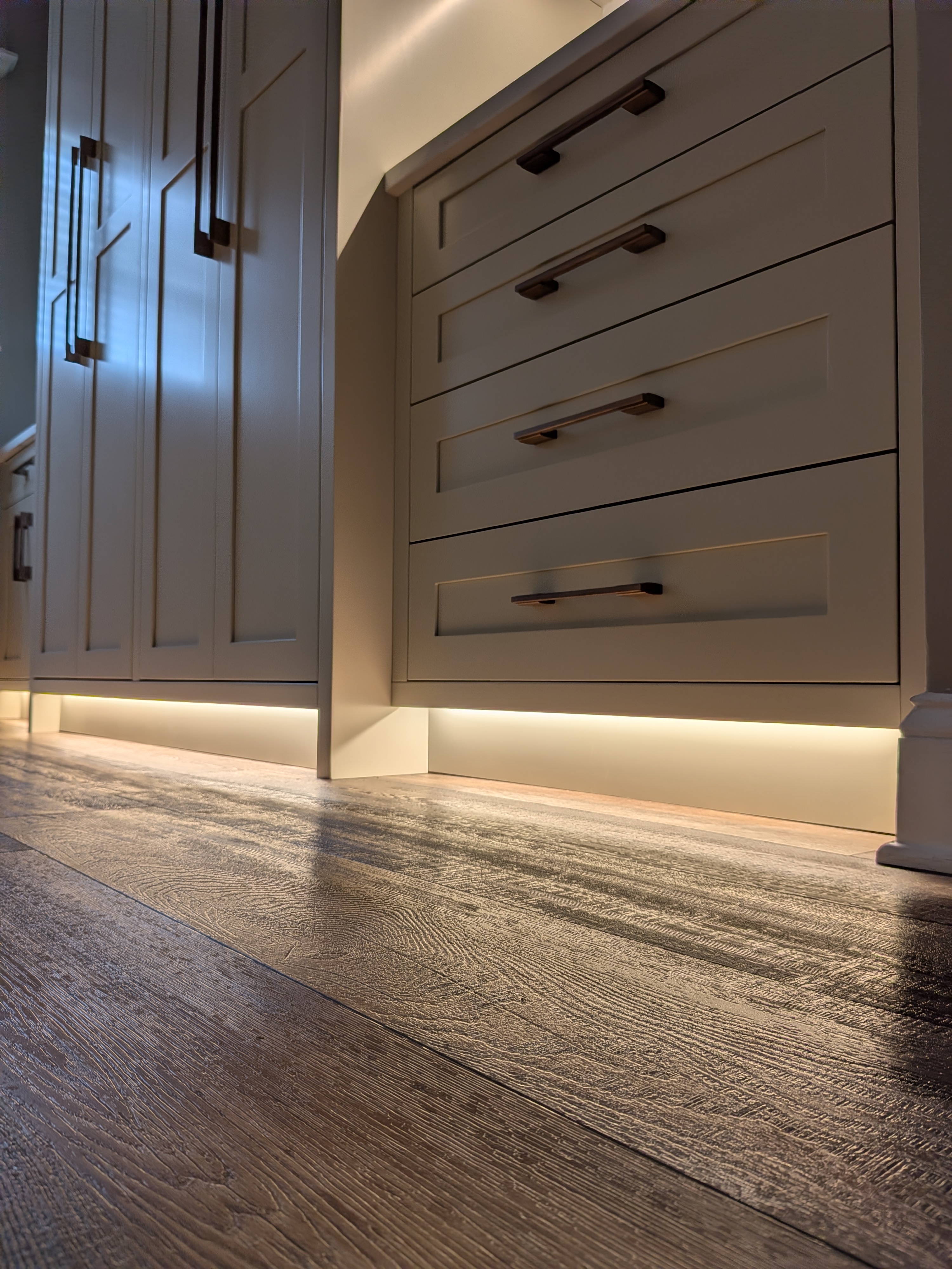 Detail shot of cabinet hardware and toe kick lighting