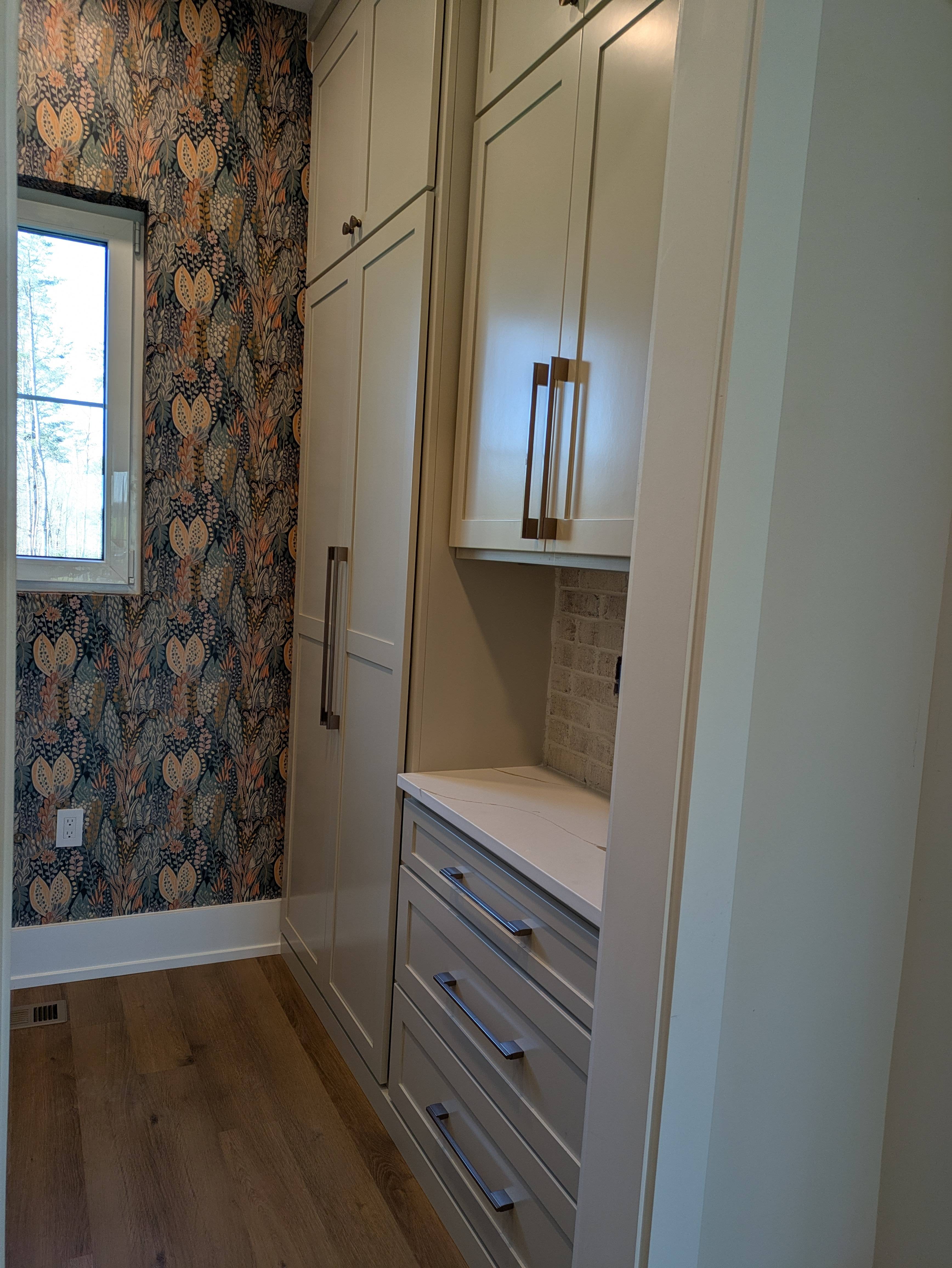Mudroom with wallpaper accent
