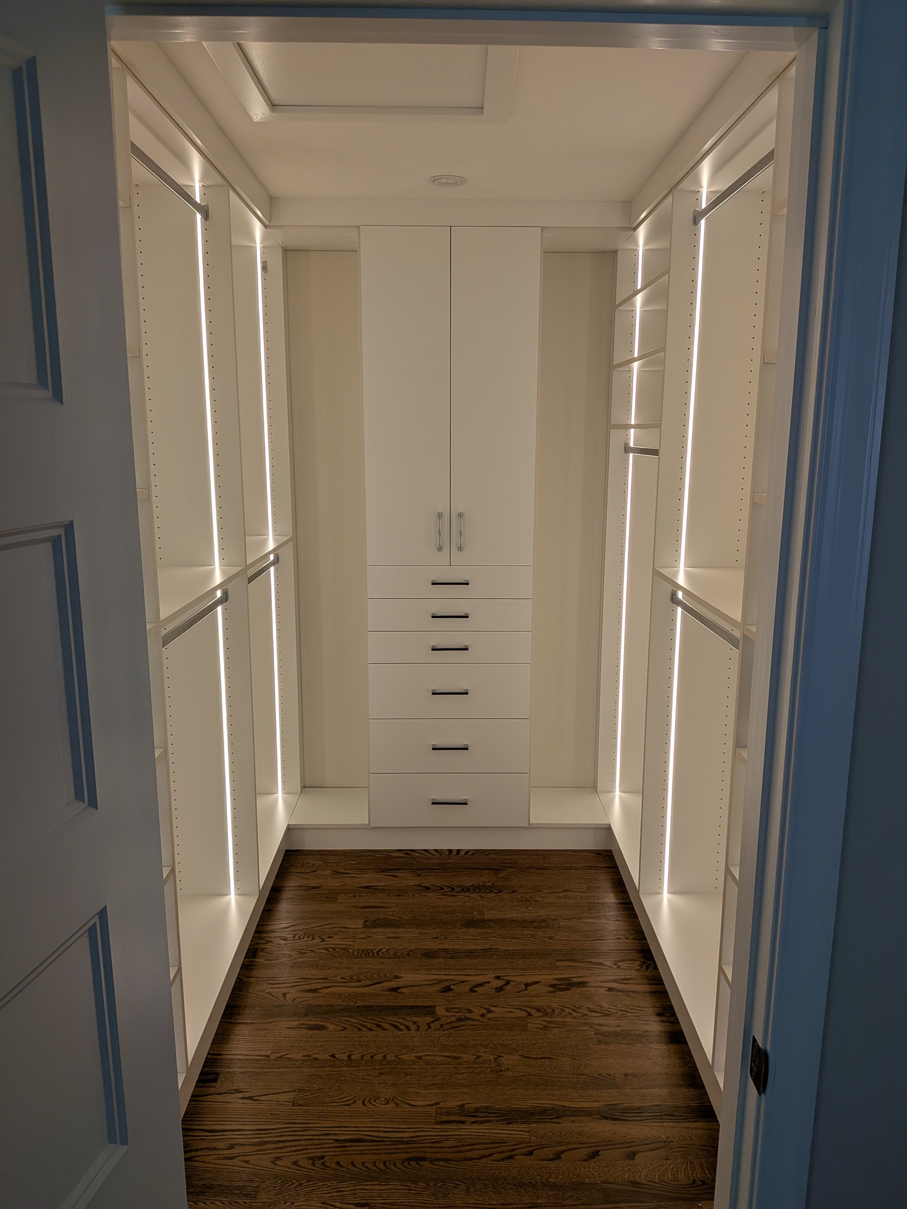 Modern white closet with LED lighting